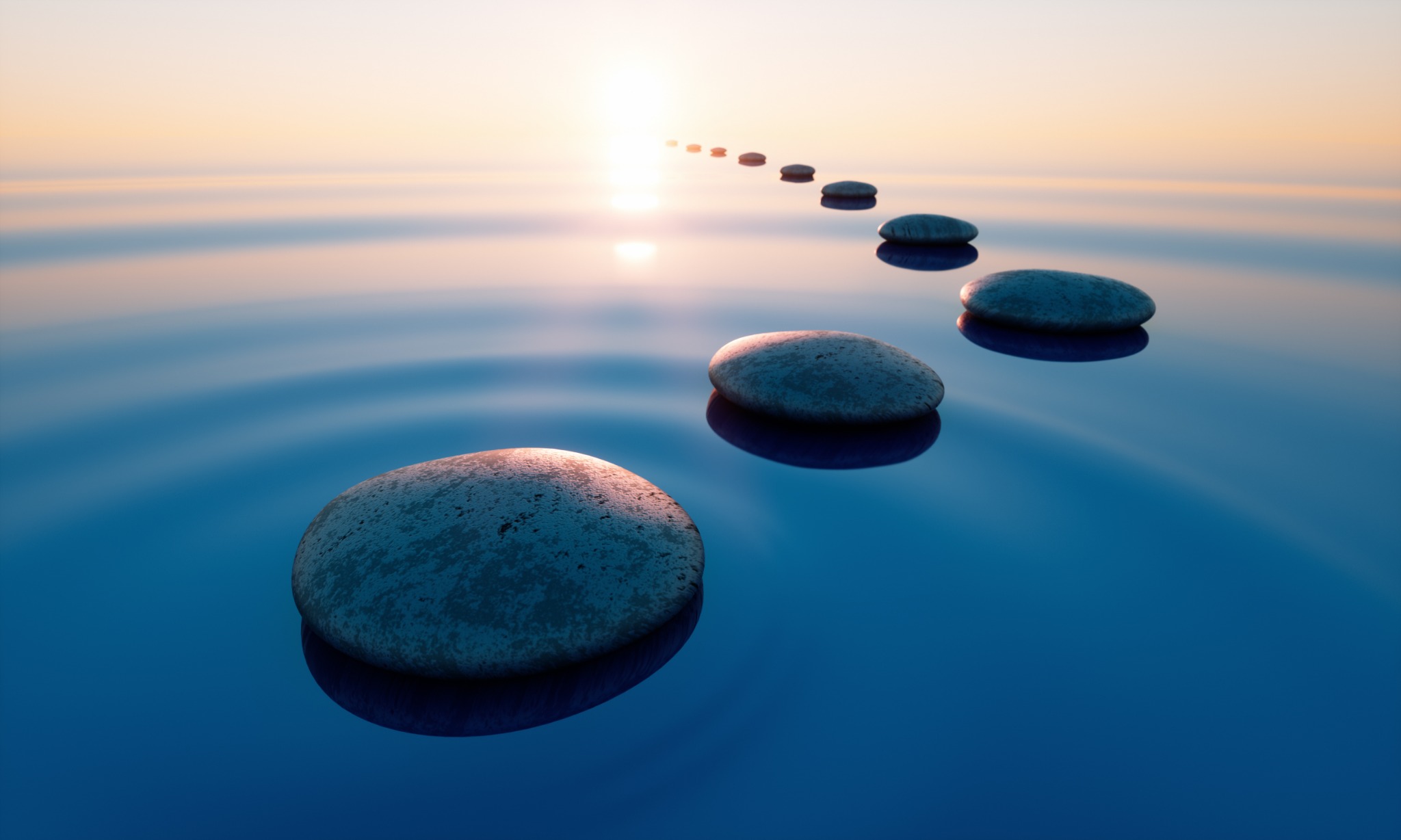 Een route van stapstenen door rustig water naar de horizon